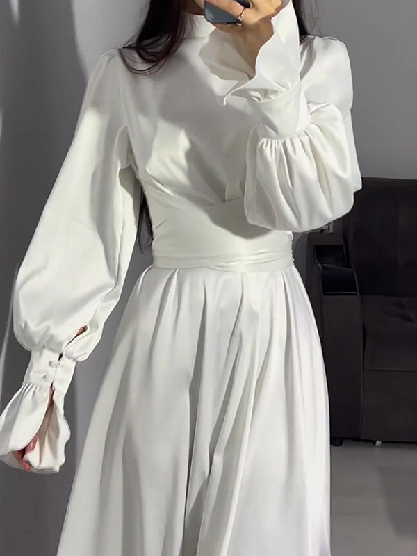 Robe longue plissée coupe trapèze, à manches longues, à taille nouée, à fermeture éclair, à col cheminée, couleur unie
