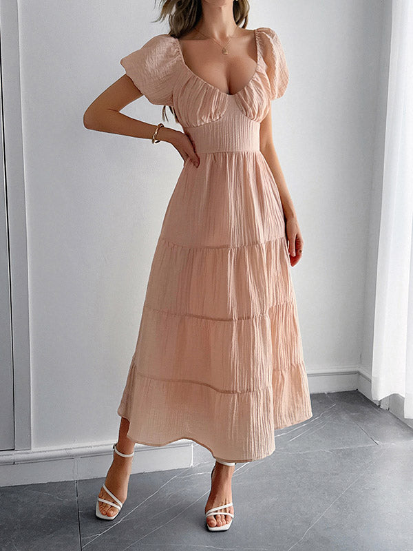 Robe mi-longue ample plissée nouée coupe trapèze, dos nu, à col en V, couleur unie