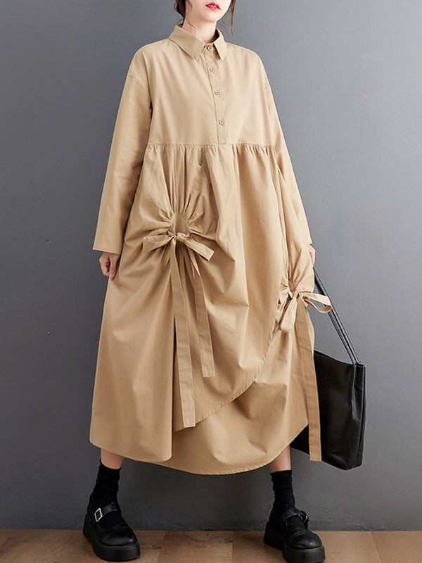 Robe chemise boutonnée plissée nouée coupe trapèze, à manches longues, à poches, à col revers, couleur unie