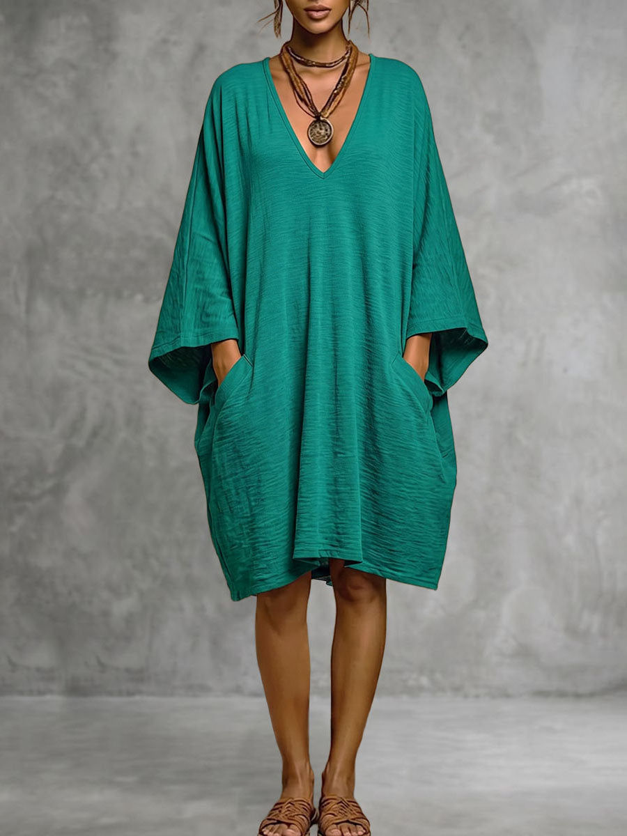 Robe mi-longue ample à manches chauve-souris, à poches, à décolleté en V profond, couleur unie