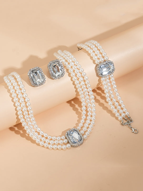 Parure bracelet, collier et boucles d'oreilles géométrique superposée à strass