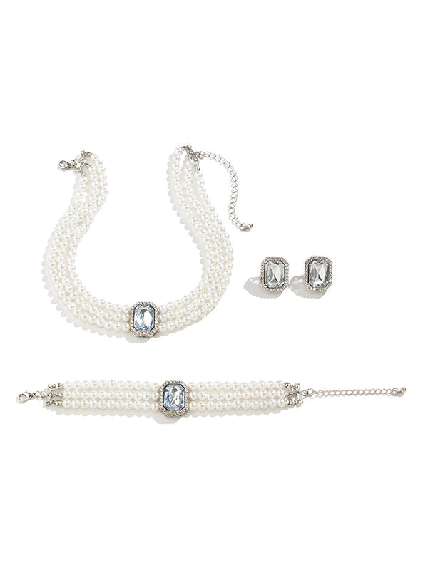 Parure bracelet, collier et boucles d'oreilles géométrique superposée à strass