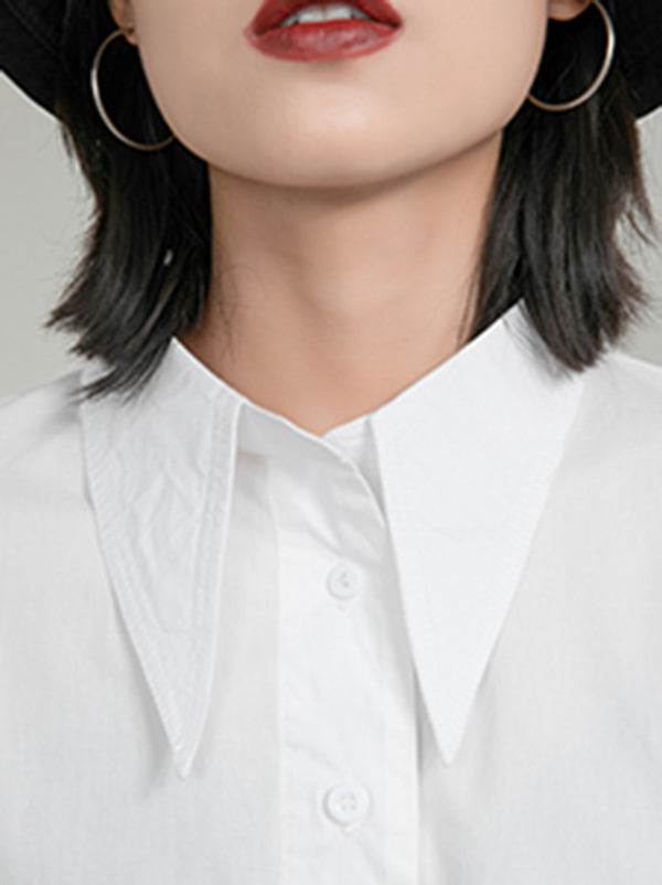 Blouse unie à coupe irrégulière et col revers