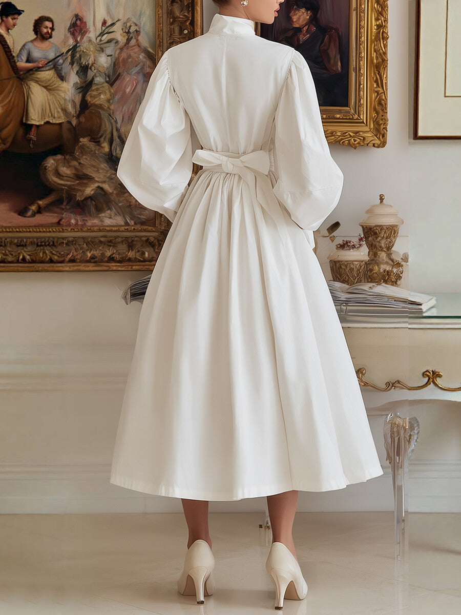 Robe mi-longue plissée coupe trapèze, taille haute, à poches, à taille nouée, à col haut, couleur unie