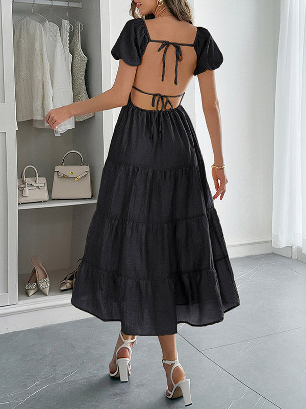 Robe mi-longue ample plissée nouée coupe trapèze, dos nu, à col en V, couleur unie