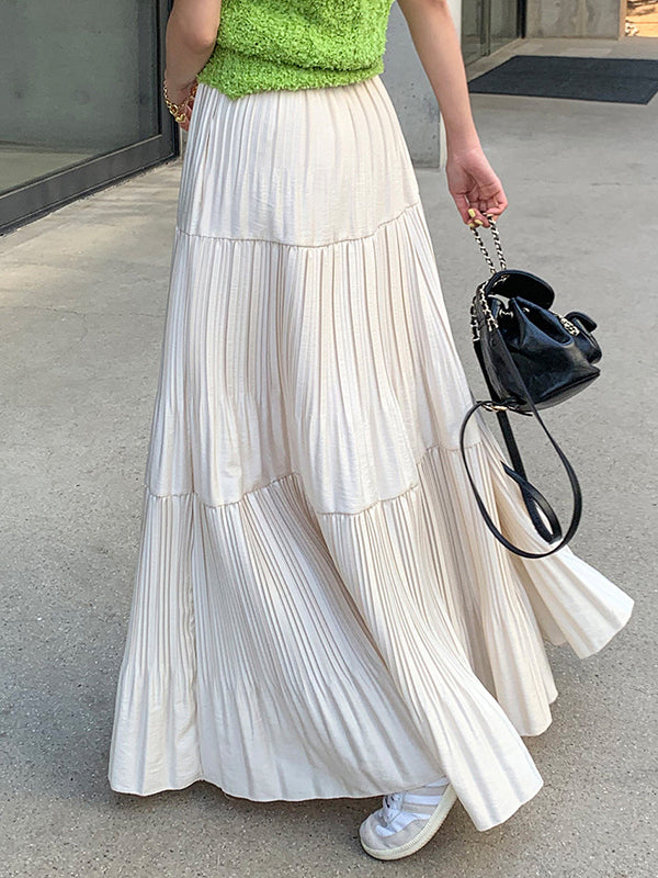 Jupe plissée coupe trapèze, taille haute, à empiècements, couleur unie