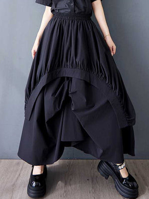 Jupe ample asymétrique plissée coupe trapèze, à taille élastique, à poches, couleur unie