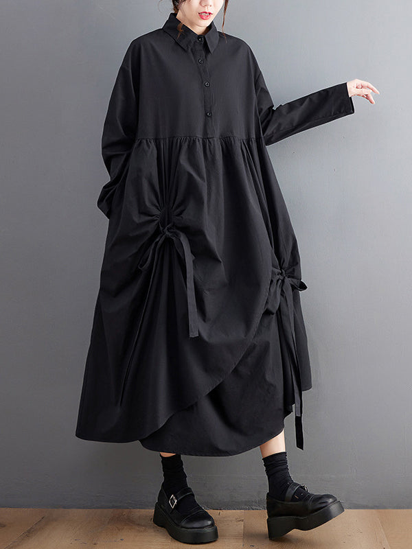 Robe chemise boutonnée plissée nouée coupe trapèze, à manches longues, à poches, à col revers, couleur unie