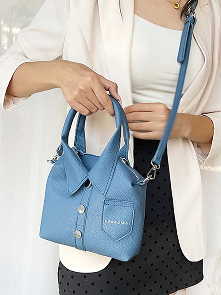 Sac à main bandoulière géométrique boutonné couleur unie