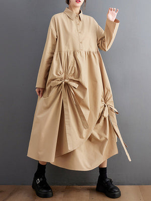Robe chemise boutonnée plissée nouée coupe trapèze, à manches longues, à poches, à col revers, couleur unie
