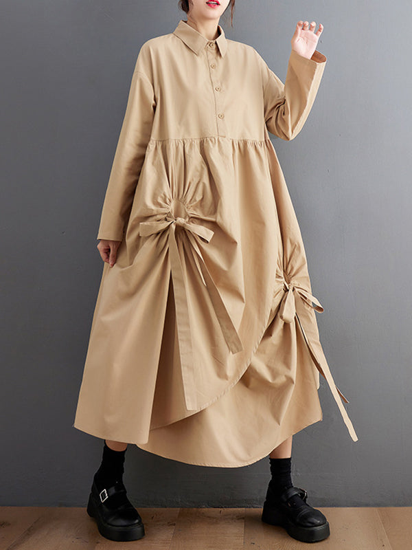 Robe chemise boutonnée plissée nouée coupe trapèze, à manches longues, à poches, à col revers, couleur unie