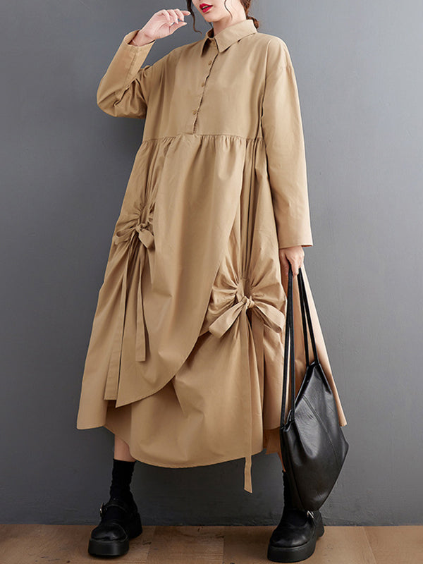 Robe chemise boutonnée plissée nouée coupe trapèze, à manches longues, à poches, à col revers, couleur unie