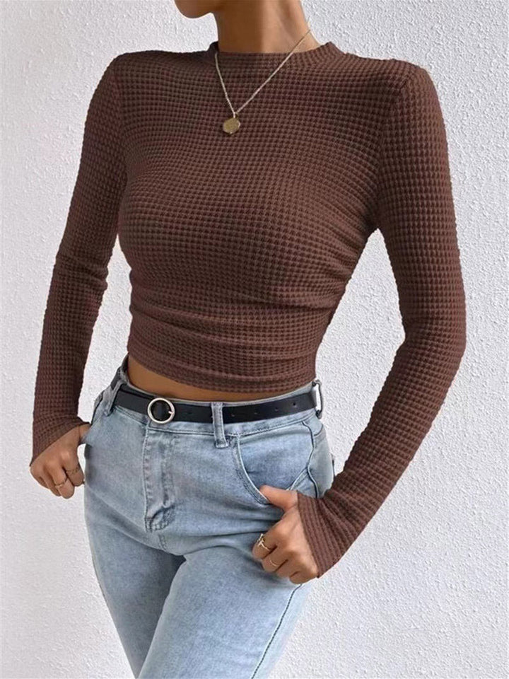 T-shirt près du corps plissé en maille gaufrée à empiècements, à manches longues et col rond, couleur unie