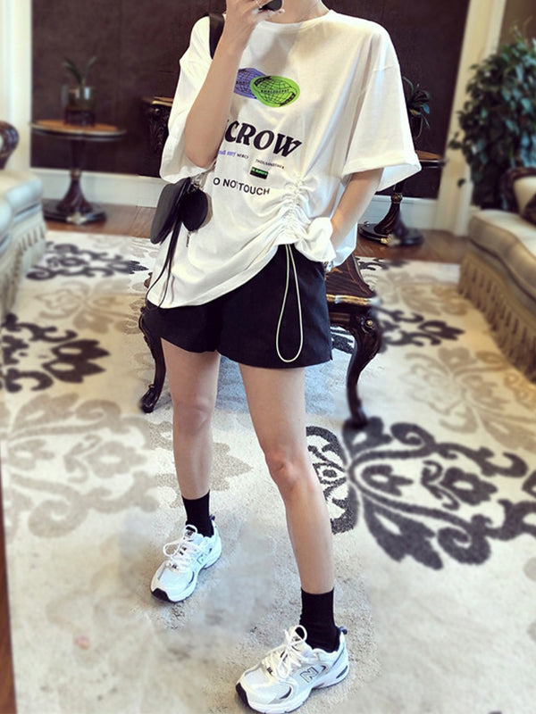 Short ample taille haute, à taille élastique, à empiècements, couleur unie