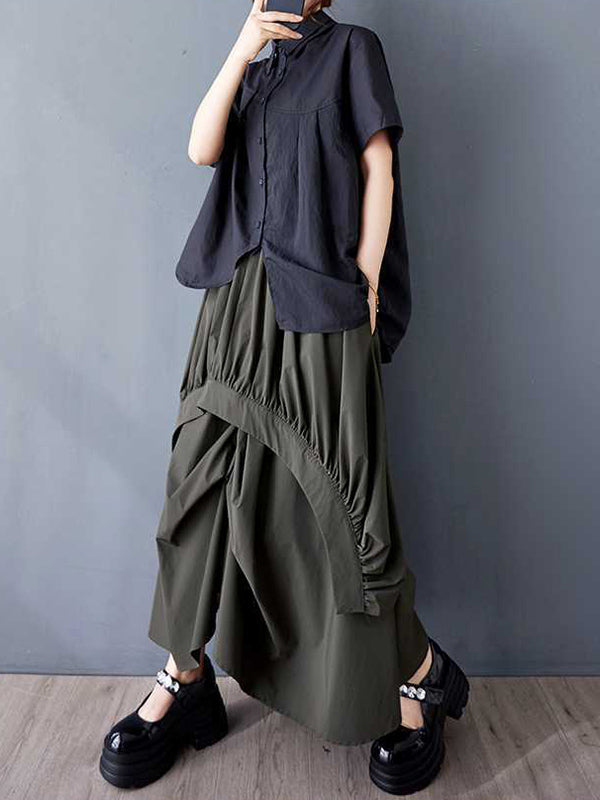 Jupe ample asymétrique plissée coupe trapèze, à taille élastique, à poches, couleur unie