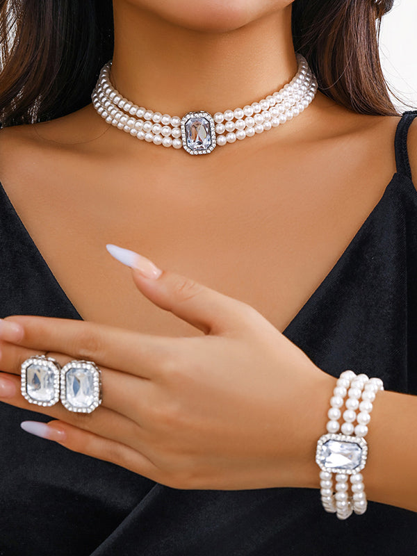 Parure bracelet, collier et boucles d'oreilles géométrique superposée à strass