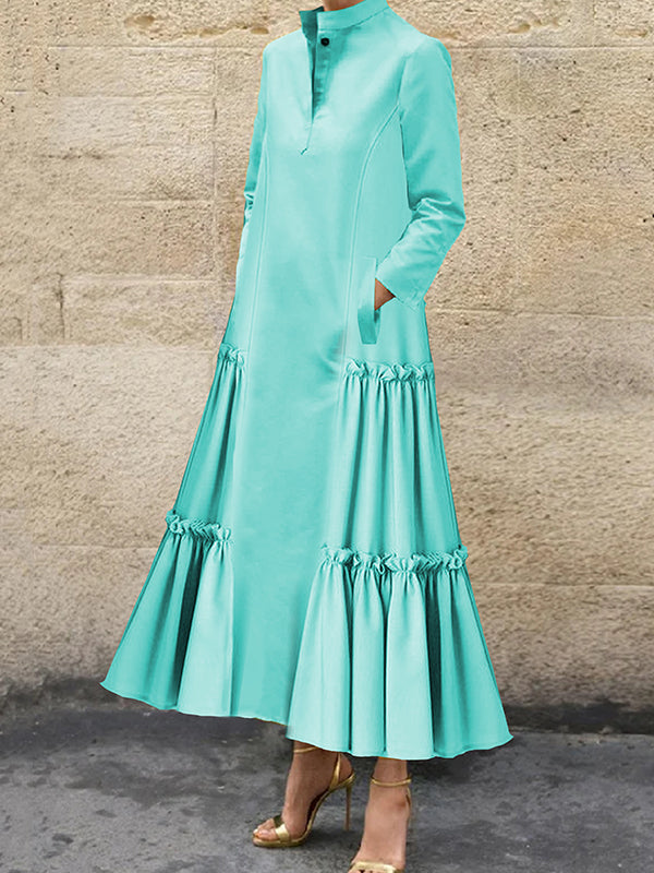 Robe longue boutonnée superposée plissée volantée coupe trapèze, à manches longues, à poches, à empiècements, à col montant, couleur unie