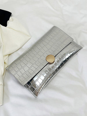Sac à main géométrique brillant à empiècements