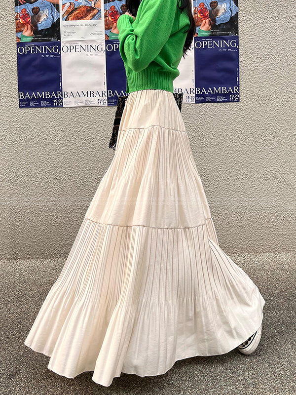 Jupe plissée coupe trapèze, taille haute, à empiècements, couleur unie