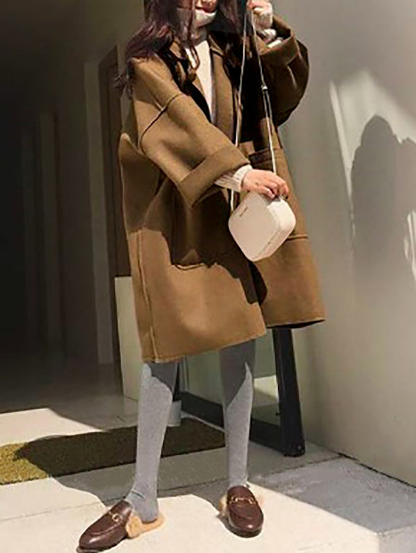 Manteau en laine ample boutonné à manches longues, à poches, à empiècements, à col cranté, couleur unie