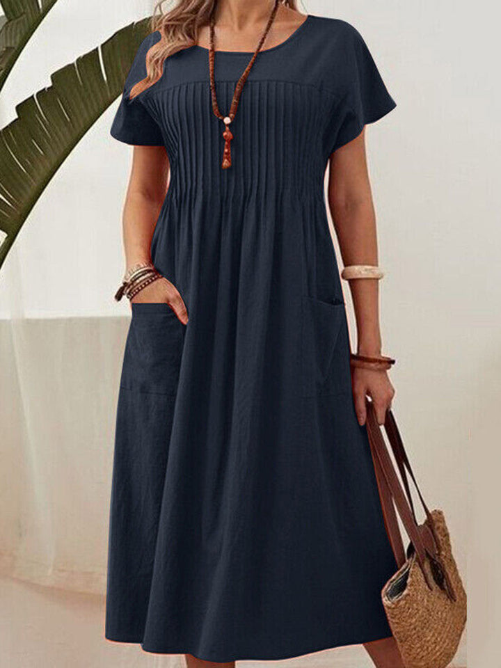 Robe mi-longue ample plissée taille haute, à poches, à empiècements, à col rond, couleur unie