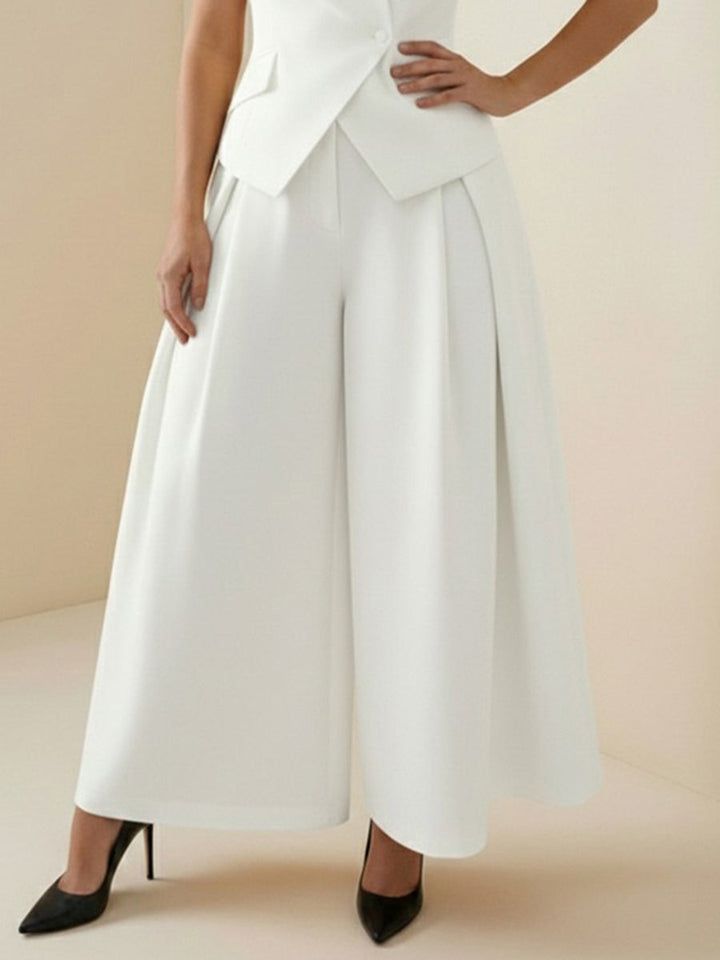 Pantalon ample plissé taille haute, à empiècements, couleur unie
