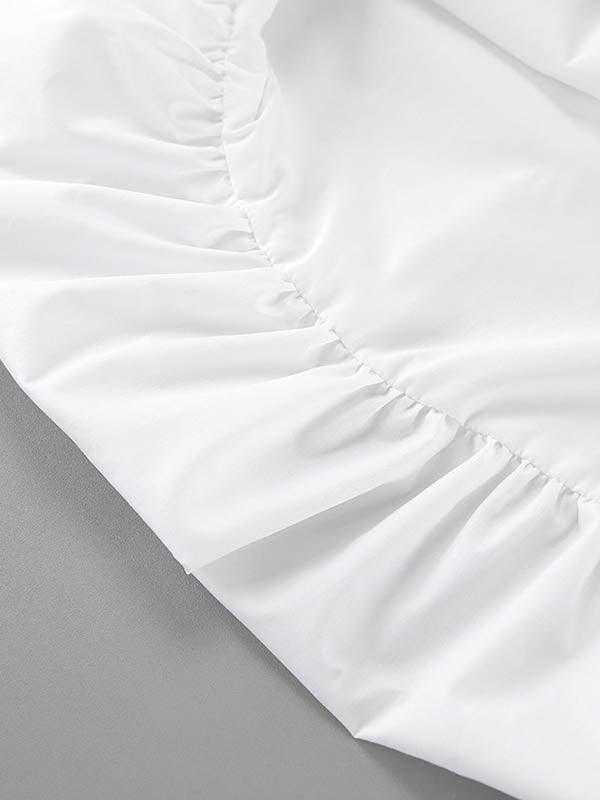 Robe mi-longue ample plissée sans manches, à empiècements, à fines bretelles, couleur unie