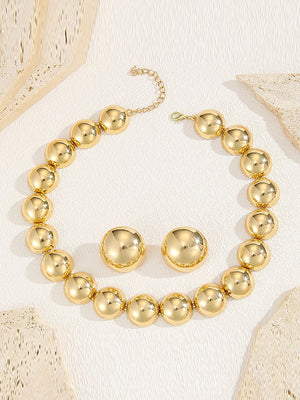 Parure collier et boucles d'oreilles perlée à empiècements, couleur unie