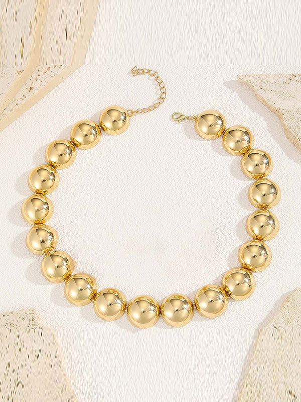 Parure collier et boucles d'oreilles perlée à empiècements, couleur unie