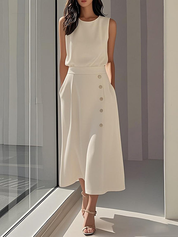 Robe mi-longue ample boutonnée sans manches, à poches, à col rond, couleur unie