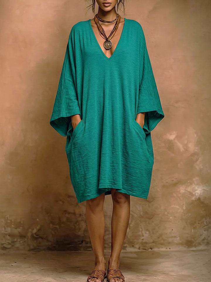Robe mi-longue ample à manches chauve-souris, à poches, à décolleté en V profond, couleur unie