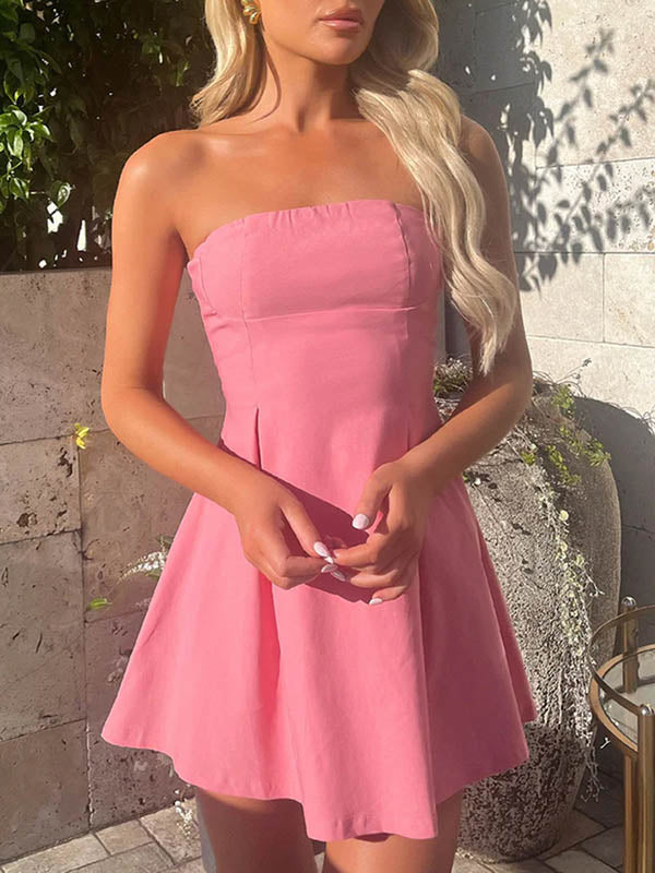 Robe courte ample plissée nouée coupe trapèze, dos nu, à empiècements, bustier, couleur unie