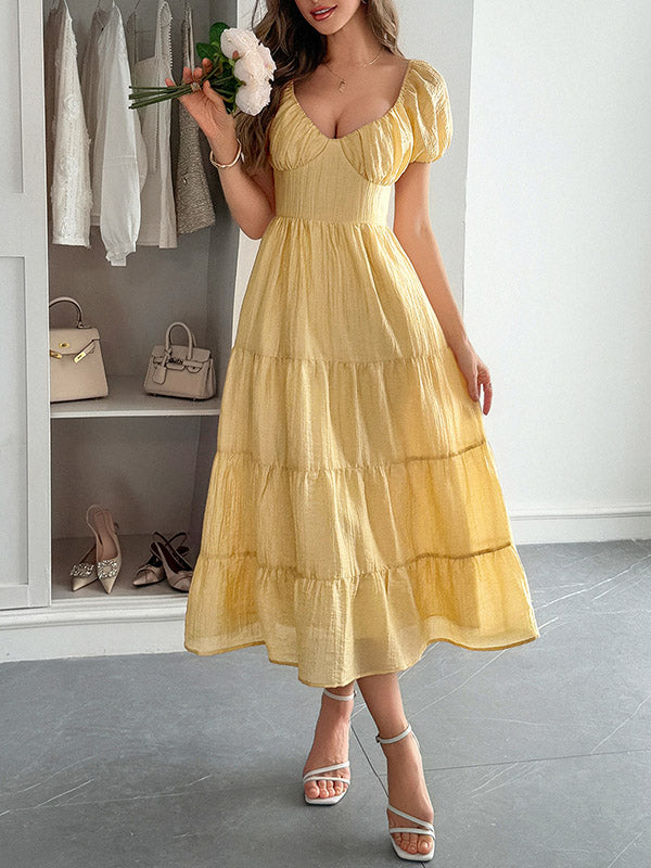 Robe mi-longue ample plissée nouée coupe trapèze, dos nu, à col en V, couleur unie