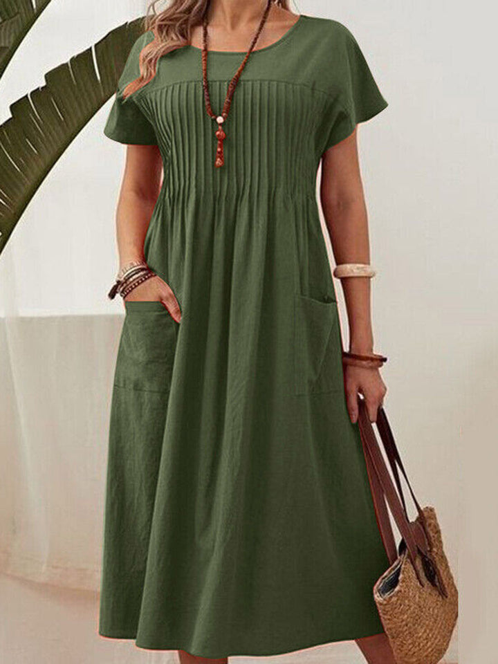 Robe mi-longue ample plissée taille haute, à poches, à empiècements, à col rond, couleur unie