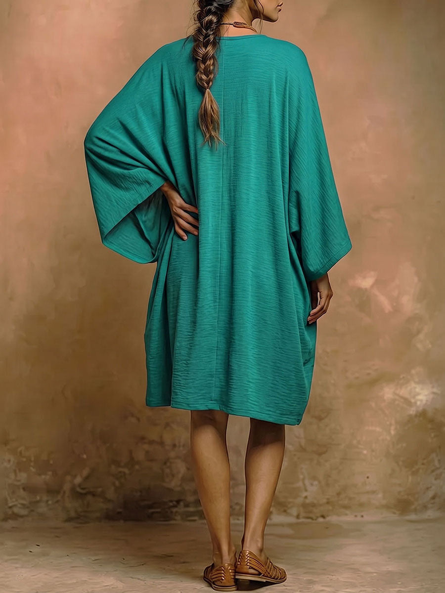 Robe mi-longue ample à manches chauve-souris, à poches, à décolleté en V profond, couleur unie