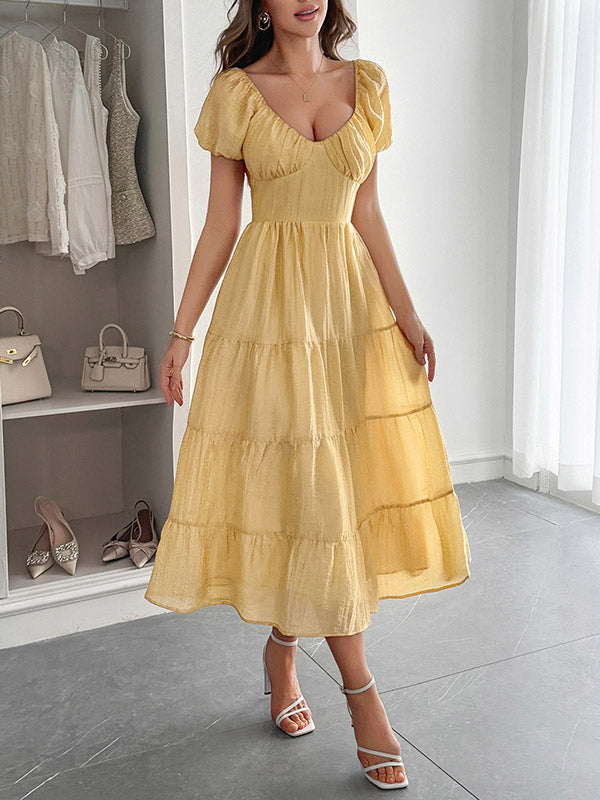 Robe mi-longue ample plissée nouée coupe trapèze, dos nu, à col en V, couleur unie