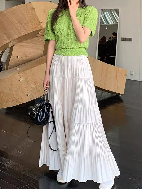 Jupe plissée coupe trapèze, taille haute, à empiècements, couleur unie