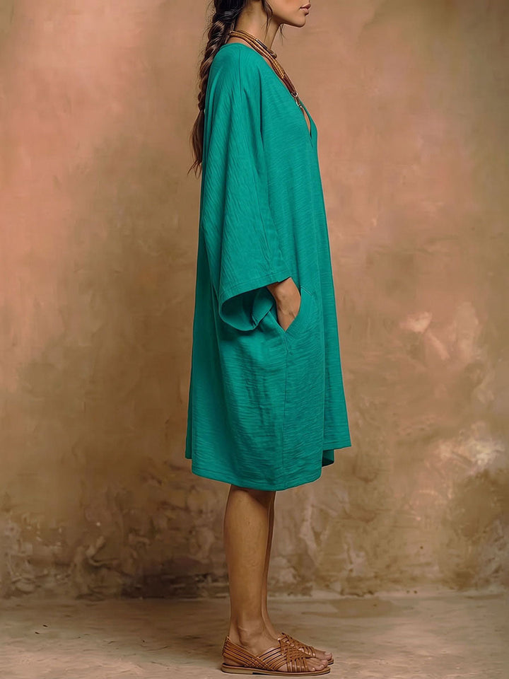 Robe mi-longue ample à manches chauve-souris, à poches, à décolleté en V profond, couleur unie