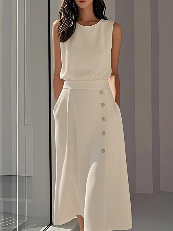Robe mi-longue ample boutonnée sans manches, à poches, à col rond, couleur unie