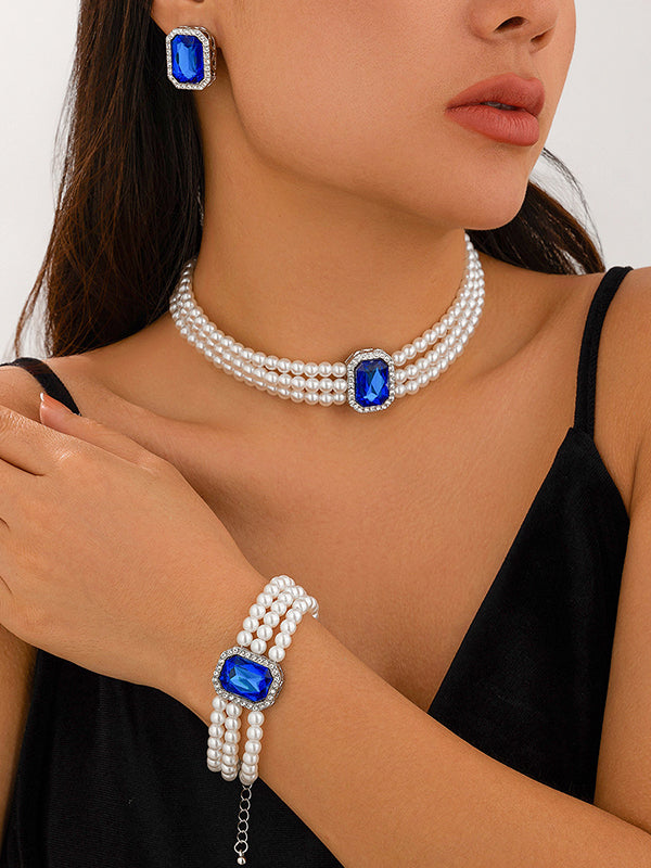 Parure bracelet, collier et boucles d'oreilles géométrique superposée à strass