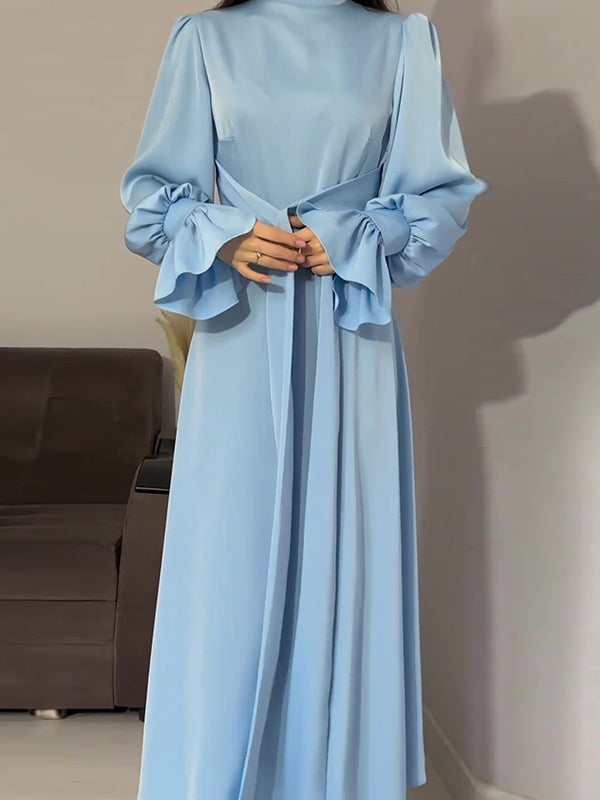 Robe longue plissée coupe trapèze, à manches longues, à taille nouée, à fermeture éclair, à col cheminée, couleur unie
