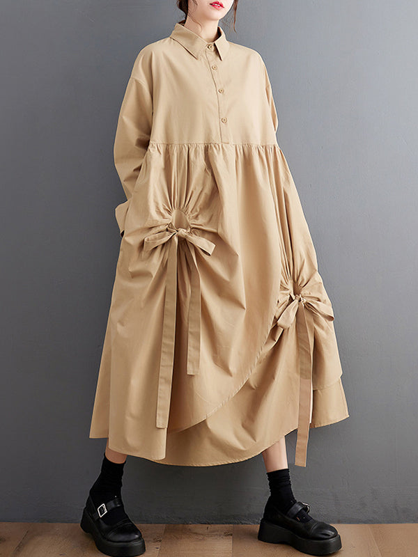 Robe chemise boutonnée plissée nouée coupe trapèze, à manches longues, à poches, à col revers, couleur unie