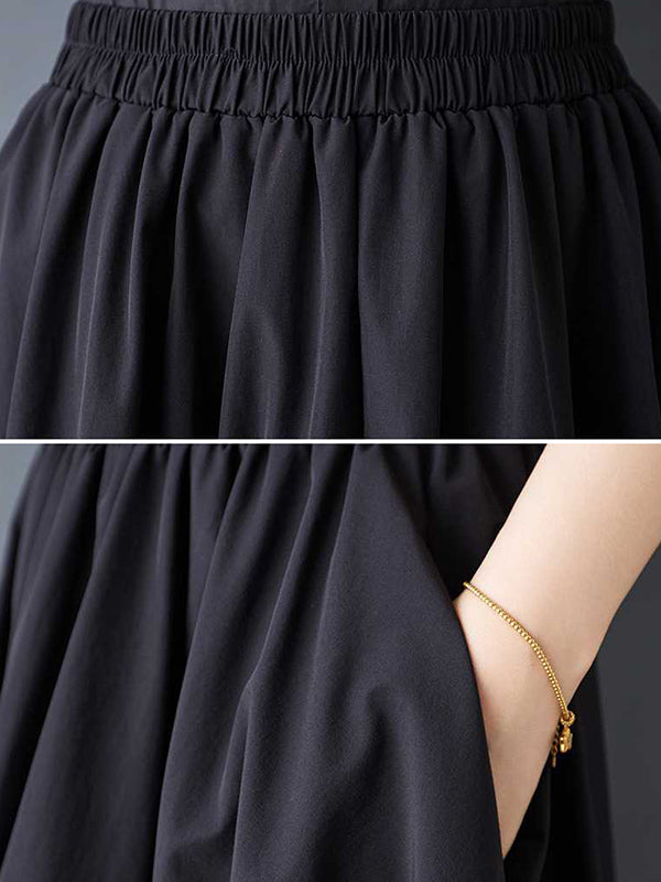 Jupe ample asymétrique plissée coupe trapèze, à taille élastique, à poches, couleur unie