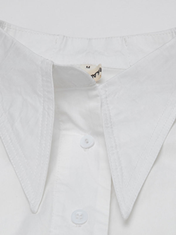 Blouse unie à coupe irrégulière et col revers