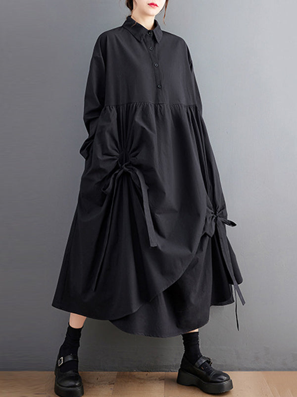Robe chemise boutonnée plissée nouée coupe trapèze, à manches longues, à poches, à col revers, couleur unie