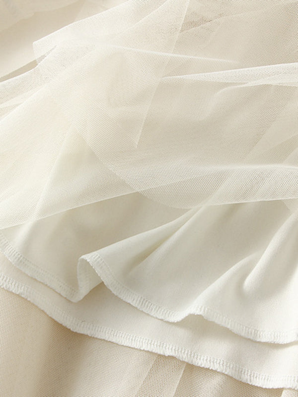 Jupe ample plissée coupe trapèze, à taille élastique, en gaze, à empiècements, couleur unie