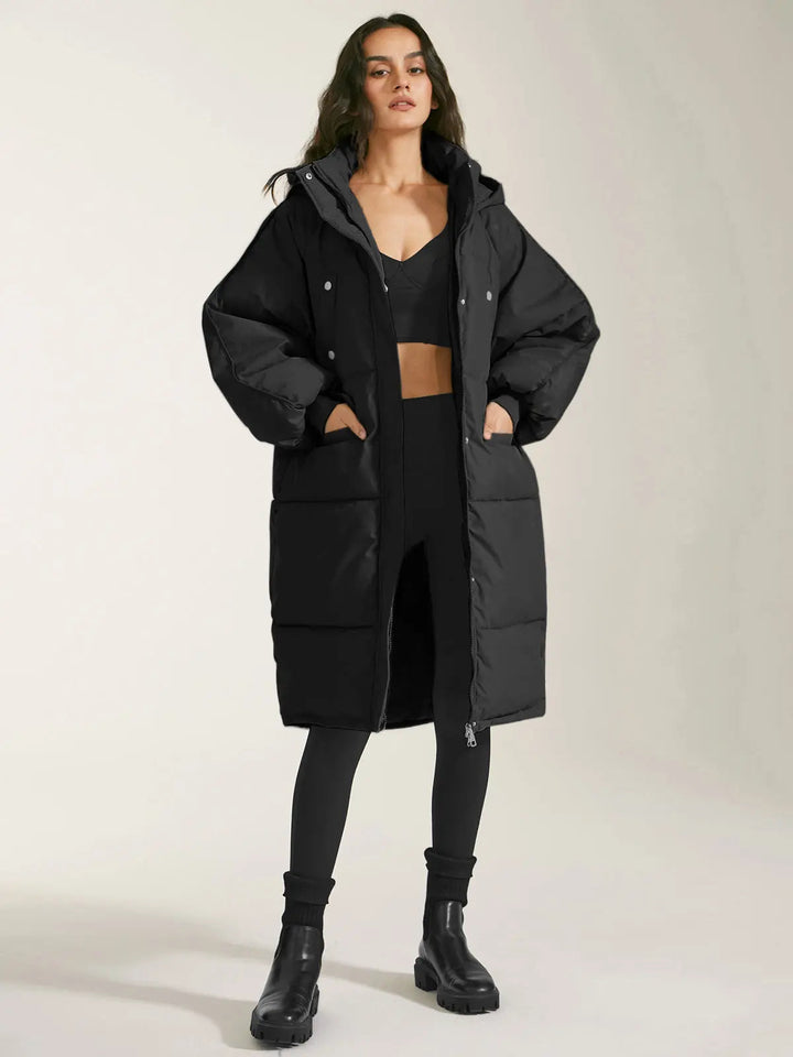 Manteau Long Matelassé pour Femmes avec Capuche, Fermeture Frontale et Poches Latérales