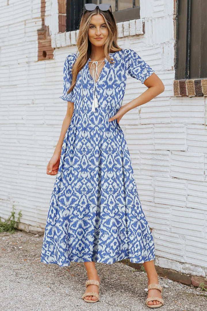 Robe midi femme avec décolleté en V et cordons à pompons, manches bouffantes courtes et jupe à volants