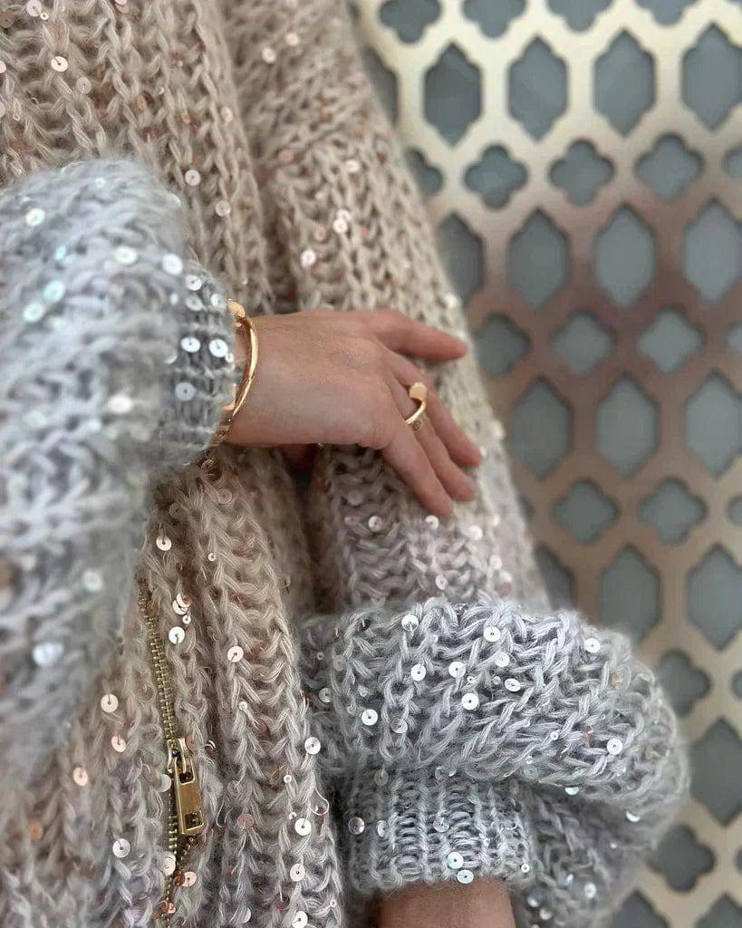Veste en tricot pour femmes avec fermeture éclair et col montant ainsi que garniture en sequins