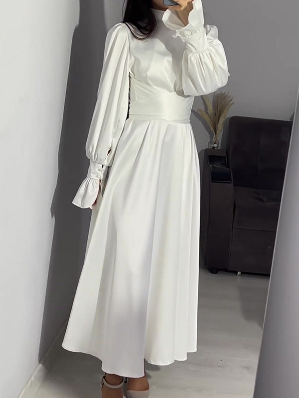Robe longue plissée coupe trapèze, à manches longues, à taille nouée, à fermeture éclair, à col cheminée, couleur unie